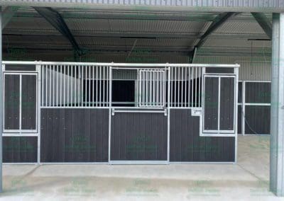 Stable panel with revolving feed bin
