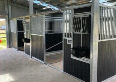 Horse stables with rotating hay and grain combo feed bin