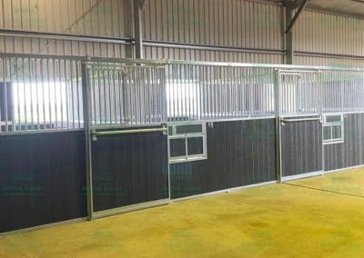 Row of new horse stables with rotating feed bins
